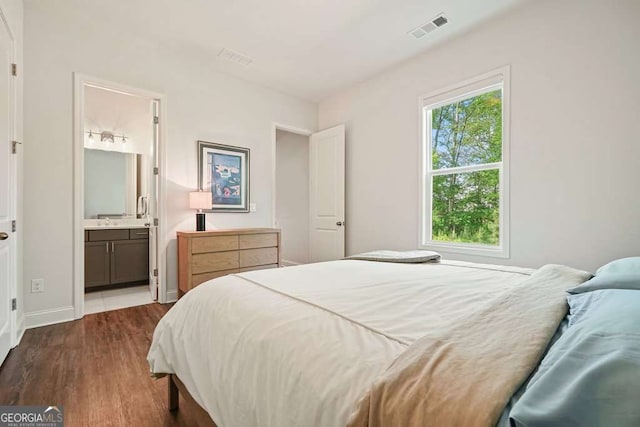 242 Fieldbrook Xing, Canton, GA 30115 - bedroom with connected bathroom, a sink, baseboards, visible vents, and dark wood-style floors