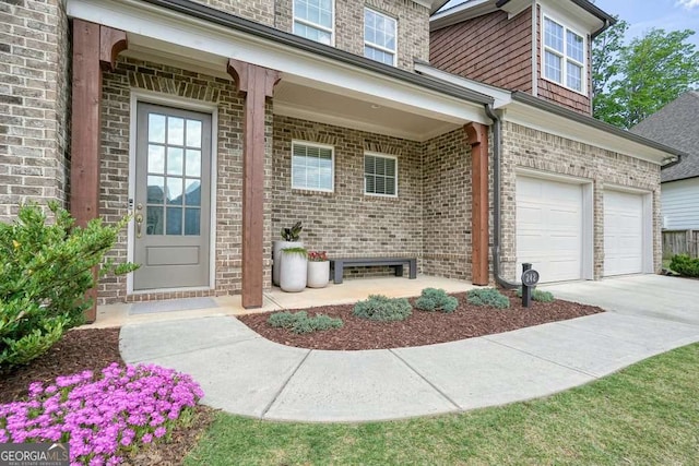 242 Fieldbrook Xing, Canton, GA 30115 - view of exterior entry with brick siding, a garage, and driveway