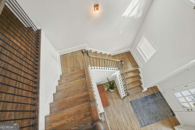 242 Fieldbrook Xing, Canton, GA 30115 - staircase with wood finished floors and a towering ceiling
