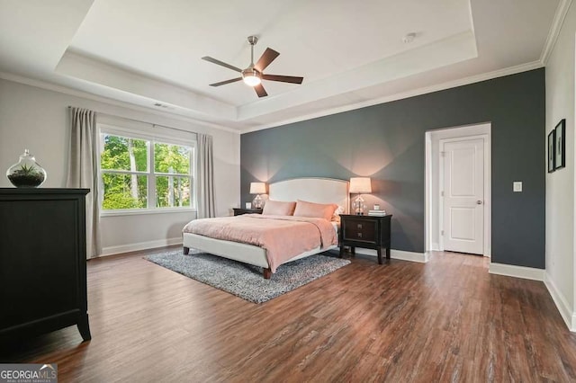 242 Fieldbrook Xing, Canton, GA 30115 - bedroom with baseboards, a tray ceiling, and wood finished floors