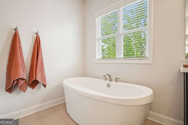 242 Fieldbrook Xing, Canton, GA 30115 - bathroom with a freestanding tub, baseboards, vanity, and tile patterned floors