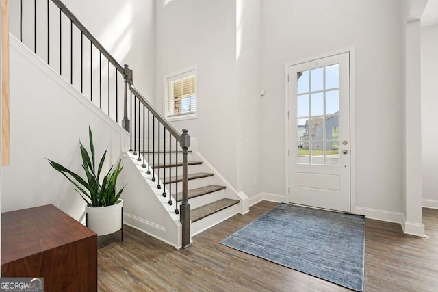 242 Fieldbrook Xing, Canton, GA 30115 - entrance foyer featuring baseboards, a high ceiling, stairs, and wood finished floors