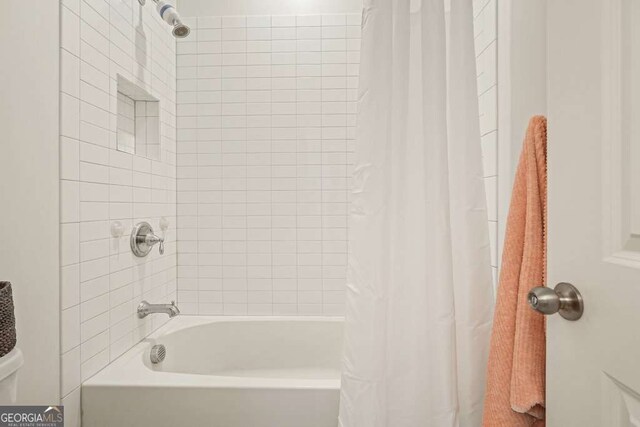 242 Fieldbrook Xing, Canton, GA 30115 - bathroom featuring shower / tub combo with curtain and toilet