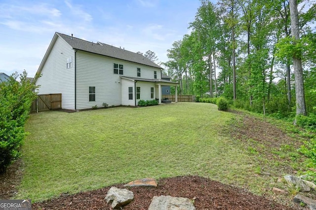242 Fieldbrook Xing, Canton, GA 30115 - back of house featuring fence and a lawn