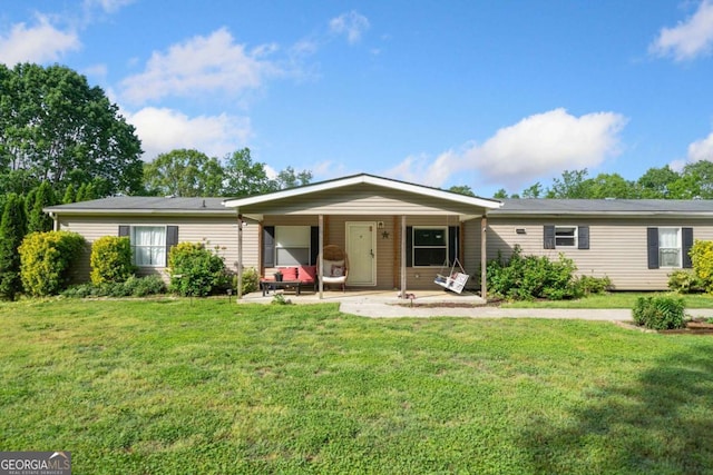ranch-style home featuring a porch and a front lawn