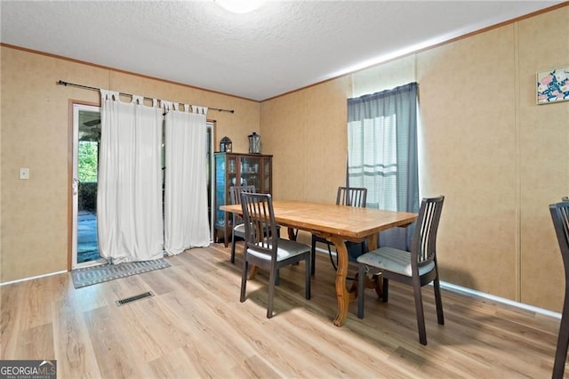 1575 Davis Rd W, Fairmount, GA 30139 - dining area featuring light wood-type flooring, a textured ceiling, crown molding, and baseboards