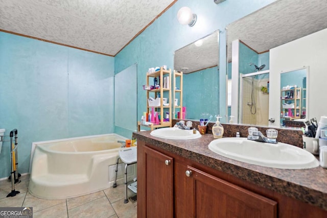 bathroom featuring a sink, a textured ceiling, tile patterned floors, and a shower stall