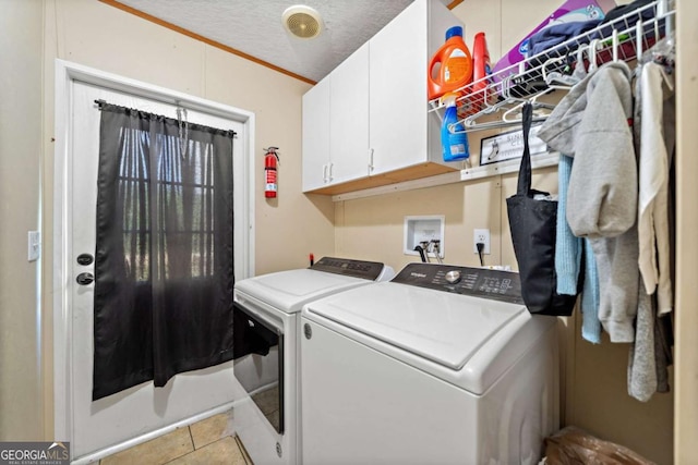 laundry room featuring separate washer and dryer, tile patterned flooring, and cabinet space