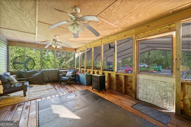 sunroom with ceiling fan and an outdoor living space