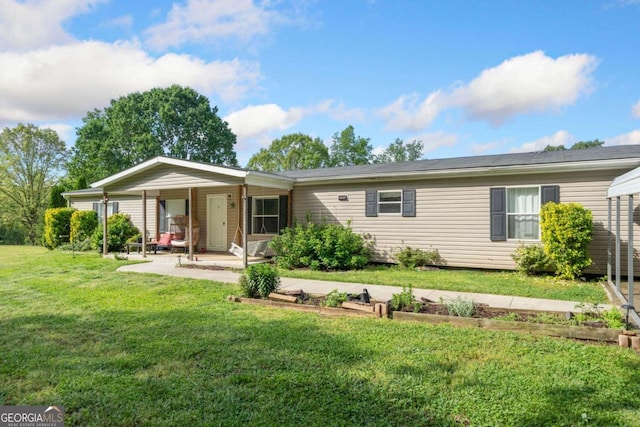 rear view of house with a lawn and covered porch