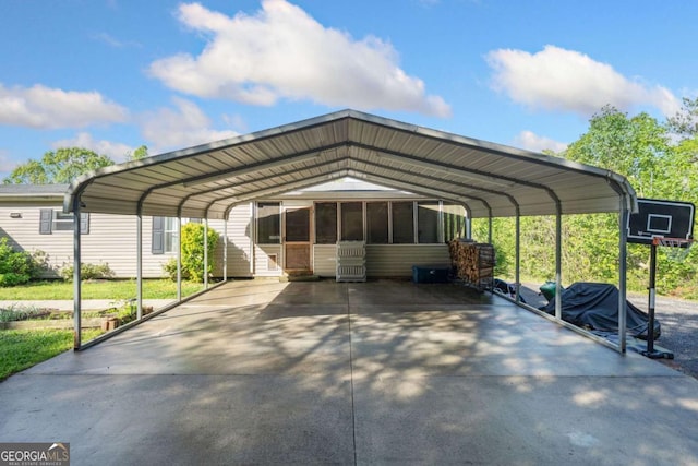 view of parking with a detached carport and concrete driveway