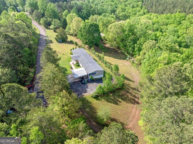 birds eye view of property with a forest view