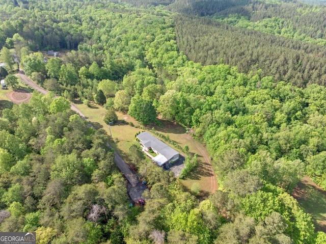 drone / aerial view featuring a view of trees