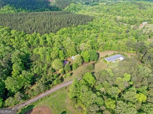 drone / aerial view featuring a forest view