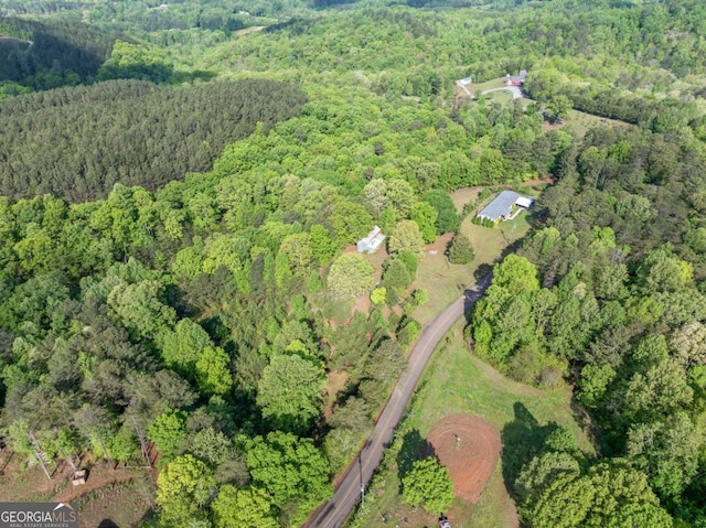 drone / aerial view with a wooded view