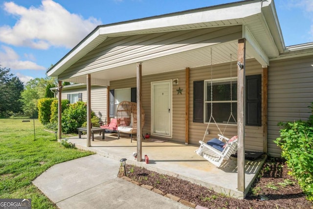 entrance to property with a yard and a porch