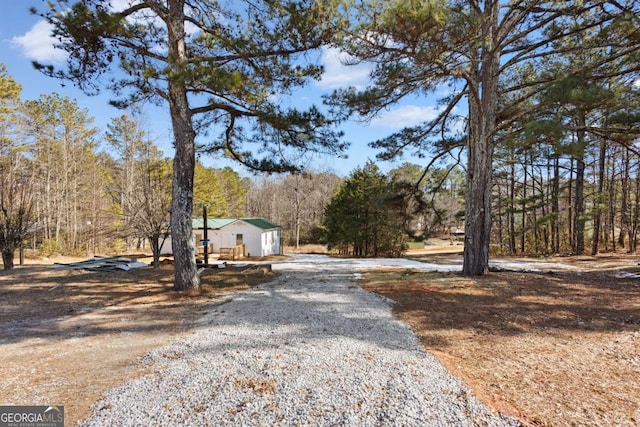 view of road with gravel driveway