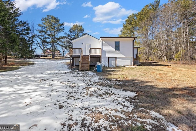 back of house featuring a wooden deck and stairway