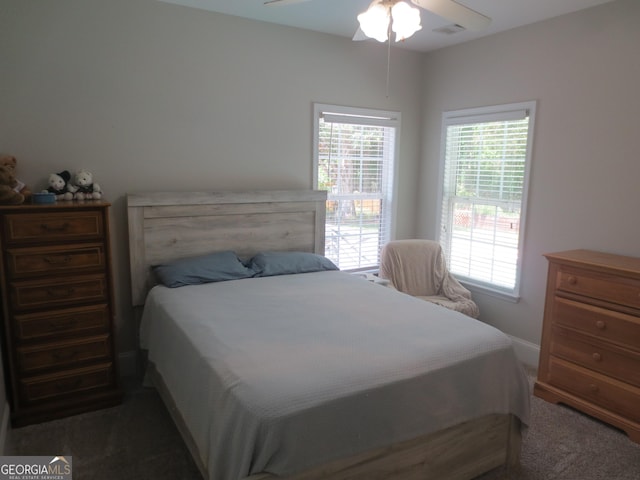 105 Wieland Dr, Kathleen, GA 31047 - carpeted bedroom with baseboards, ceiling fan, visible vents, and multiple windows