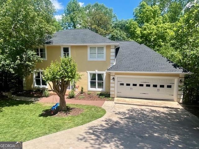 1536 Enota Ave NE, Gainesville, GA 30501 - view of front of home with concrete driveway, a garage, stucco siding, a front yard, and roof with shingles