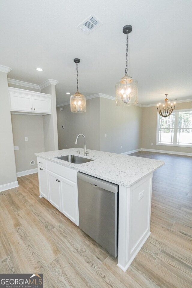 kitchen with visible vents, dishwasher, a sink, white cabinets, and ornamental molding