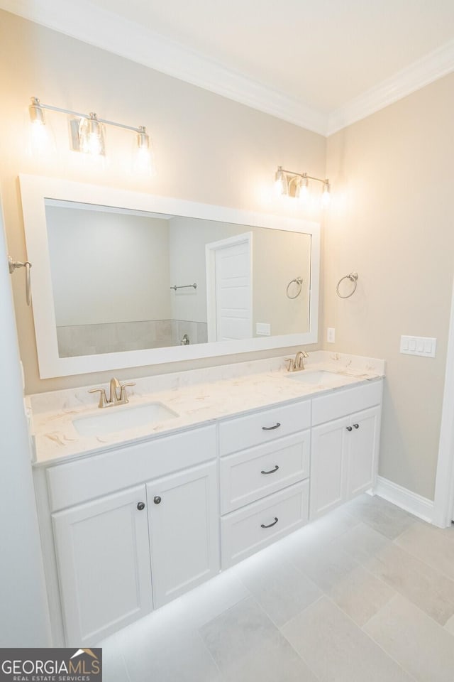 full bath featuring crown molding, a sink, and double vanity