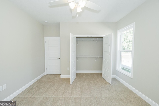 unfurnished bedroom featuring a closet, carpet flooring, baseboards, and a ceiling fan