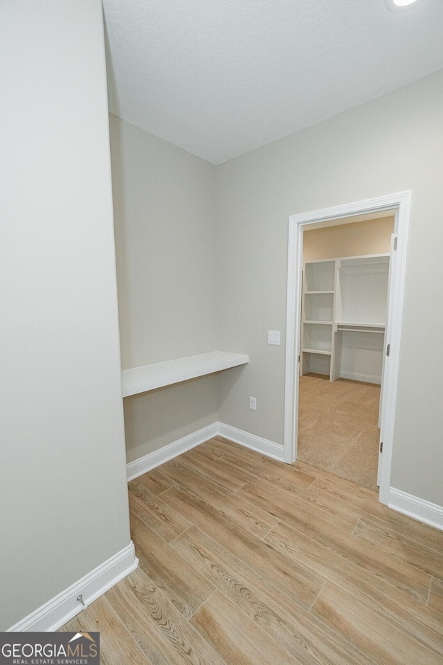 interior space featuring baseboards and wood finished floors