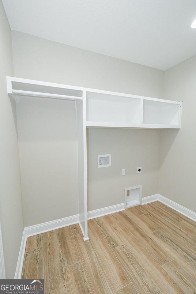 laundry area featuring washer hookup, hookup for an electric dryer, laundry area, wood finished floors, and baseboards