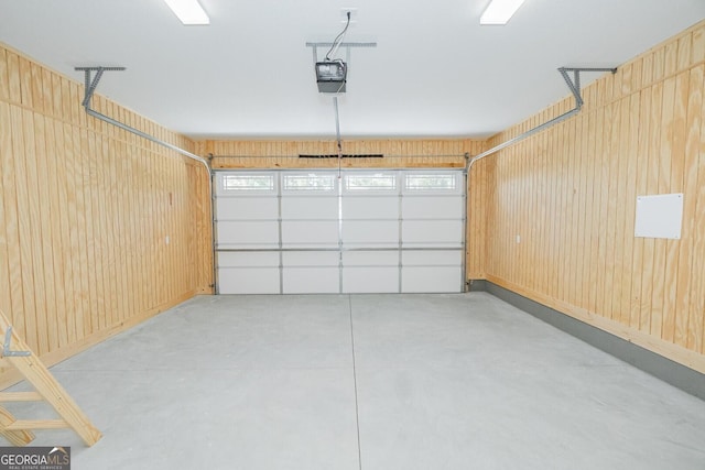 garage with wooden walls and a garage door opener