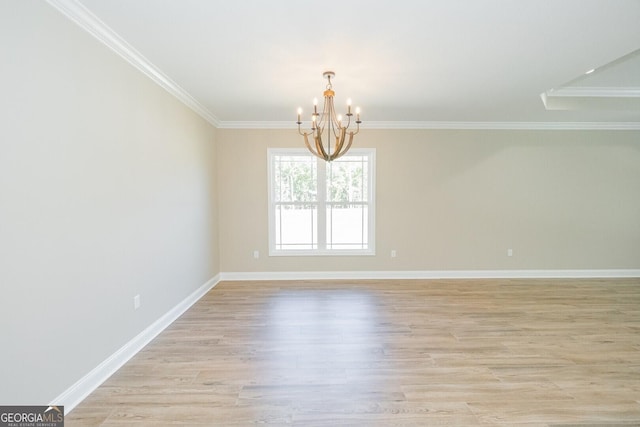 unfurnished dining area with an inviting chandelier, ornamental molding, light wood-style flooring, and baseboards