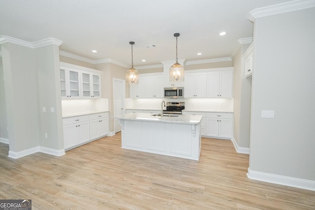 kitchen with white cabinetry, appliances with stainless steel finishes, and light wood finished floors