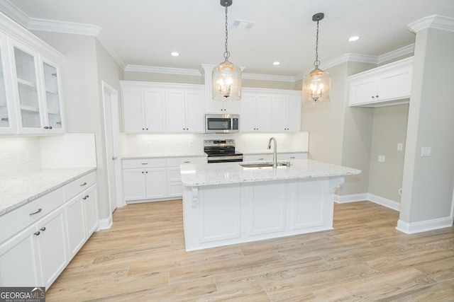 kitchen featuring a sink, decorative backsplash, stainless steel appliances, and white cabinetry