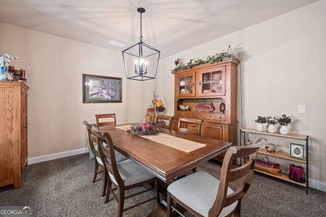 dining area with baseboards, dark colored carpet, and a notable chandelier