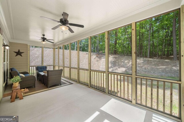 sunroom / solarium featuring ceiling fan and outdoor lounge area