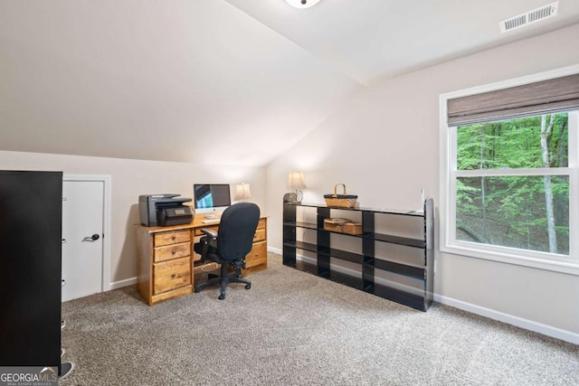 carpeted office space featuring baseboards, visible vents, and lofted ceiling