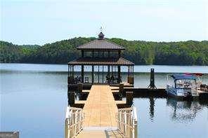 dock area with a water view and a forest view