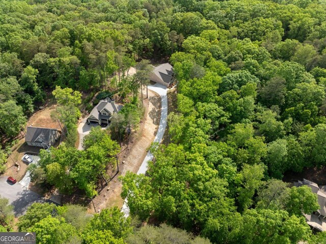 birds eye view of property with a view of trees