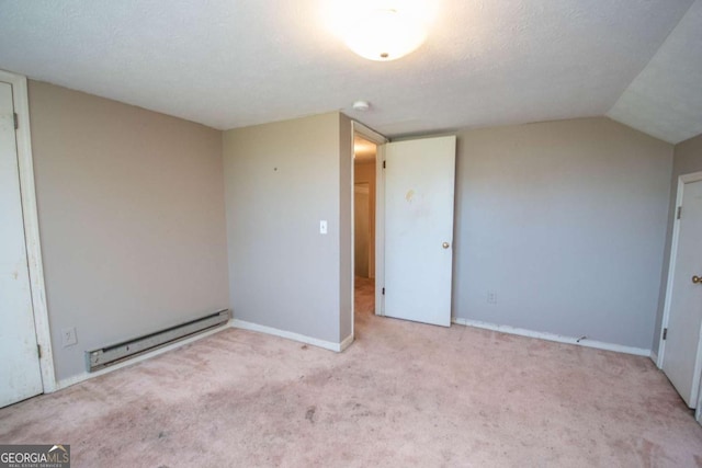 unfurnished bedroom featuring baseboards, lofted ceiling, baseboard heating, and carpet