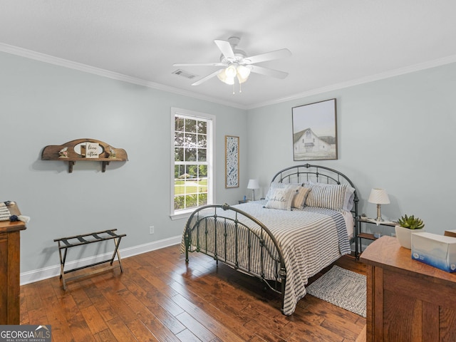 bedroom featuring baseboards, ornamental molding, ceiling fan, visible vents, and hardwood / wood-style flooring