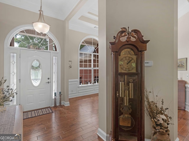 foyer featuring crown molding, hardwood / wood-style flooring, and beamed ceiling