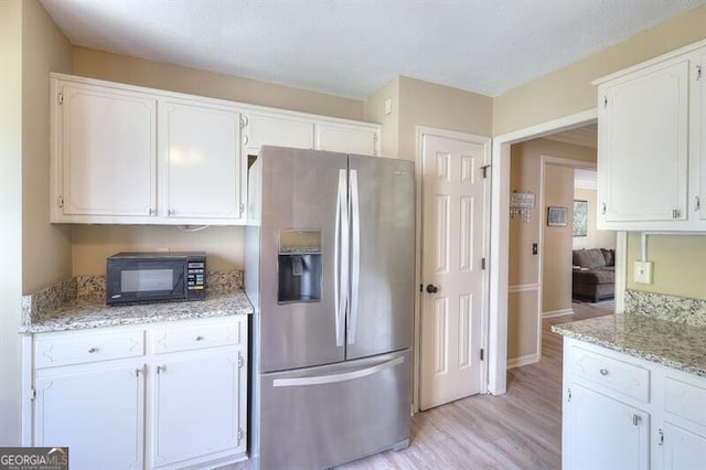 3716 Meeting St, Duluth, GA 30096 - kitchen featuring white cabinetry, black microwave, and stainless steel refrigerator with ice dispenser