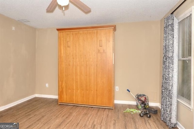 3716 Meeting St, Duluth, GA 30096 - interior space with a textured ceiling, baseboards, a ceiling fan, and wood finished floors