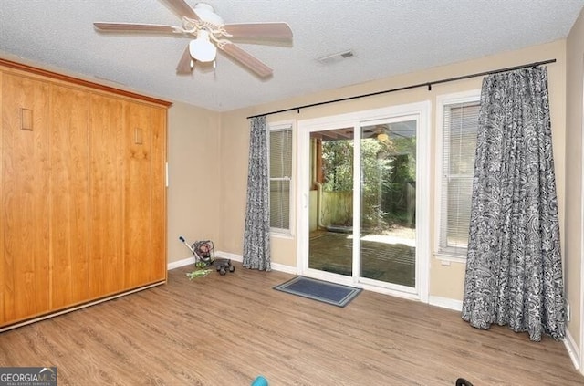 3716 Meeting St, Duluth, GA 30096 - empty room featuring light wood-style flooring, a ceiling fan, a textured ceiling, visible vents, and baseboards