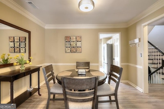 3716 Meeting St, Duluth, GA 30096 - dining room with ornamental molding, stairway, visible vents, and wood finished floors