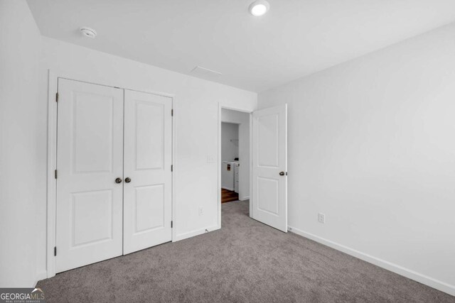 828 Evergreen Rd, Winder, GA 30680 - unfurnished bedroom featuring baseboards, carpet, and a closet
