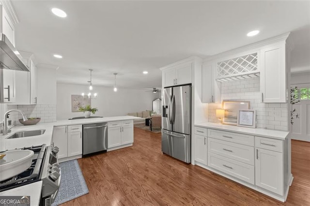 800 Breckinridge Rd SW, Marietta, GA 30064 - kitchen with stainless steel appliances, white cabinetry, a sink, and tasteful backsplash