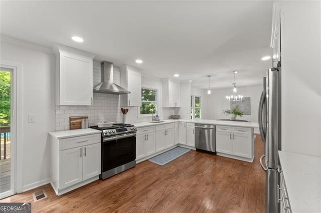800 Breckinridge Rd SW, Marietta, GA 30064 - kitchen featuring wall chimney range hood, appliances with stainless steel finishes, a sink, tasteful backsplash, and visible vents