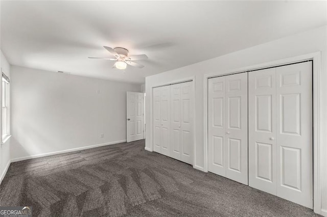 800 Breckinridge Rd SW, Marietta, GA 30064 - unfurnished bedroom with carpet floors, baseboards, a ceiling fan, and multiple closets