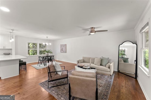 800 Breckinridge Rd SW, Marietta, GA 30064 - living area featuring baseboards, ceiling fan with notable chandelier, wood finished floors, and a healthy amount of sunlight